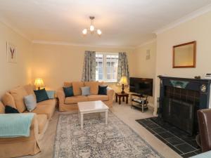 a living room with couches and a fireplace at Wolds Way in Bainton