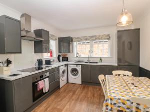 a kitchen with a sink and a dishwasher at Wolds Way in Bainton