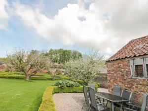 a patio with a table and chairs in a yard at Wolds Way in Bainton