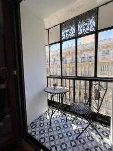 a room with a table and a window at Hostal Arenal Madrid in Madrid