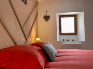 a bedroom with a red bed with a window at Rooftop N°38 - Rooms et Studios - Vue Cité Médiévale in Carcassonne +32 photos