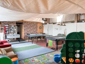 a room with two ping pong tables in a room at The Hereford - Uk44694 in Cheadle