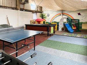 a room with a ping pong table and a playground at The Hereford - Uk44694 in Cheadle