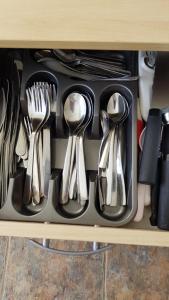 a drawer filled with utensils on a shelf at Comfortable Family Home in Immingham in Immingham