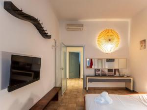 a bedroom with a bed and a flat screen tv at [Stazione SMN]Art House Florence in Florence