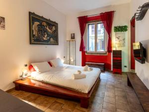 a bedroom with a bed and a red wall at [Stazione SMN]Art House Florence in Florence