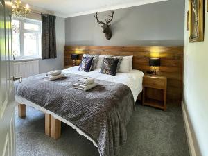a bedroom with a bed with two towels on it at Keepsake View in Two Dales