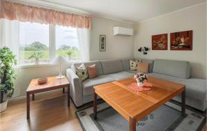 a living room with a couch and a table at Stunning Home In Lttorp With 2 Bedrooms in Löttorp