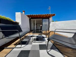 a deck with chairs and a table on a house at Rooftop N°38 - Rooms et Studios - Vue Cité Médiévale in Carcassonne