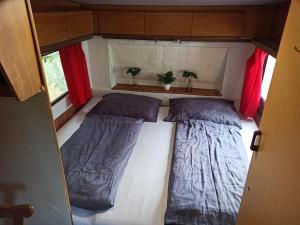 a small room with two beds in a trailer at Odpočinek na venkově 