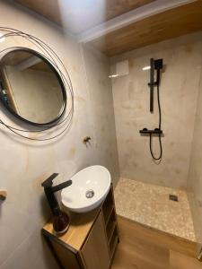 a bathroom with a sink and a mirror at Tiny house Malý gurmán 