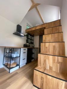 a kitchen with a wooden staircase in a room at Tiny house Malý gurmán 