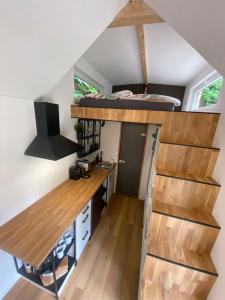 a tiny house with a loft bed and a desk at Tiny house Malý gurmán 