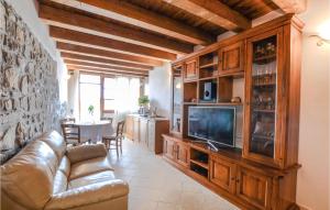 a living room with a couch and a tv at Beautiful Home In Comano With Wifi And 3 Bedrooms in Comano