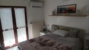 ein Schlafzimmer mit einem Bett und einem TV an der Wand in der Unterkunft Casa Emily in Fano