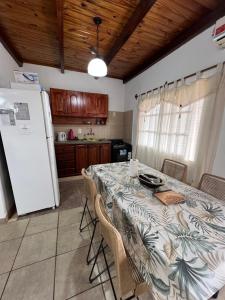 a kitchen with a table with chairs and a refrigerator at Departamento de La Nonna in Posadas
