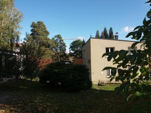 a white house with trees in front of it at DIVADELNÍ PENZION 