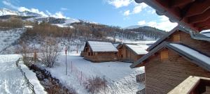a group of wooden cabins in the snow at Appartement coeur de station village Saint Francois Longchamp in Saint-François-Longchamp
