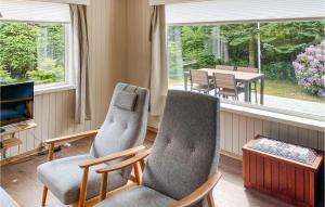 a living room with two chairs and a television and a table at 2 Bedroom Gorgeous Home In Nrb in Nærbø