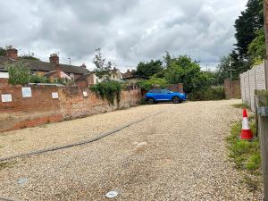 a blue car parked on the side of a road at Flat 03 Studio flat near Aylesbury Station Free Parking in Buckinghamshire