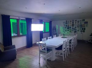 a dining room with a white table and chairs at The Croft Accommodation in Gamrie