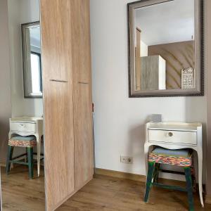 a bathroom with a wooden door next to a mirror at Luxurious Green Garden Flat by SUMMITVISTA in Istanbul