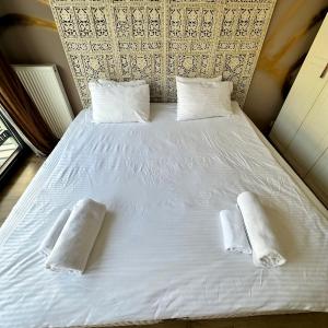 a large white bed with two white pillows on it at Luxurious Green Garden Flat by SUMMITVISTA in Istanbul