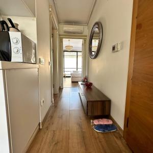 a hallway of a kitchen with a refrigerator and a table at Luxurious Green Garden Flat by SUMMITVISTA in Istanbul