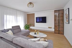 a living room with a couch and a table at Luxury Apartments Luna in Tučepi