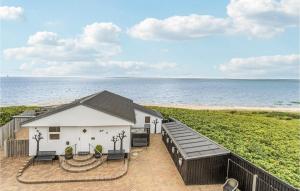 a house on the beach with the ocean in the background at Stunning Home In Esbjerg V With Wifi in Esbjerg