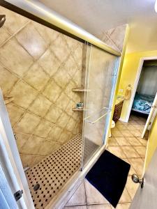a shower with a glass door in a bathroom at Harbor View 2bed 1bath Loft In Downtown Red Hook! in East End