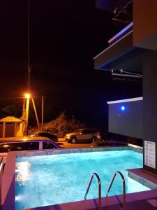 a swimming pool at night in a hotel at Blue Star #4 in Paralia Katerinis