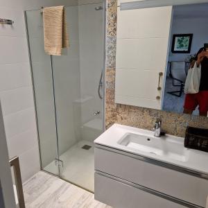a bathroom with a sink and a shower at Costa Luz Sirens Beach in Los Pocillos