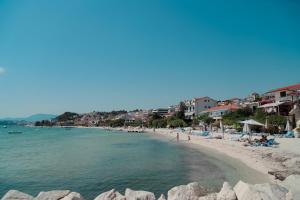 a beach with a bunch of people and the water at Elite estate in Podstrana