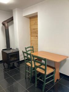 a table and chairs and a stove in a room at Na Mlejně in Telč