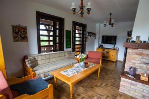 a living room with a couch and a coffee table at White Dove Pension in Miercurea-Ciuc