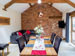 a dining room with a table and chairs at Blackberry Barn in Tortworth