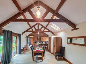 a kitchen and dining room with a table and chairs at Blackberry Barn in Tortworth