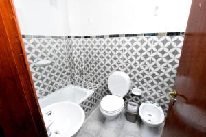 a bathroom with a white toilet and a sink at Cálido Destino in Ushuaia