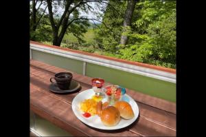 a plate of breakfast food on a table with a window at Guest house KURIHAI - Vacation STAY 09979v in Oita
