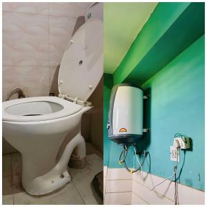a bathroom with a toilet and a soap dispenser at OYO Hotel Verma Residency in Katra