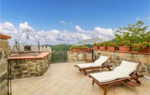 a patio with two chairs and a grill at 3 Bedroom Cozy Home In Comano in Comano