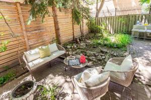 a patio with a couch and chairs and a table at Sweet Home in Toronto