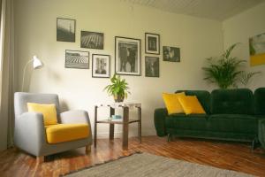 a living room with two green couches and a table at Lovely nest in Nõmme in Tallinn