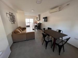 ein Wohnzimmer mit einem Tisch und einem Sofa in der Unterkunft Departamento Nº 3 en complejo semiprivado! 2 habitaciones in San Martín