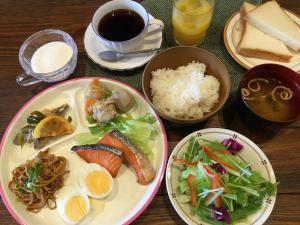 Mizuho Inn Iwami Masuda - Vacation STAY 17362v في ماسودا: طاولة مع أطباق من الطعام وكوب من القهوة