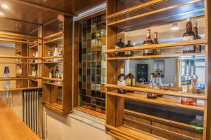 a bar with many bottles of alcohol on shelves at Urban Oasis, Stylish Short Stay Apartment in Piraeus Center in Piraeus