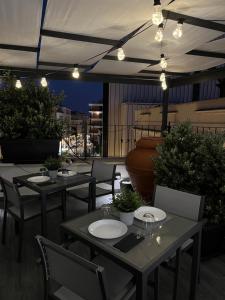 a restaurant with tables and chairs on a roof at Terrazza Poesìa in Brindisi