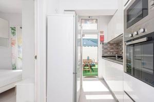 a kitchen with a glass door leading to a dining room at Casa de Moscavide 19 in Lisbon