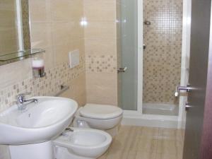 a bathroom with a sink and a toilet and a shower at B&B FreeZone in Modugno